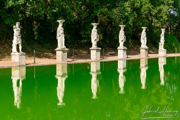 Statues reflected in green water at Villa Adriana near Rome