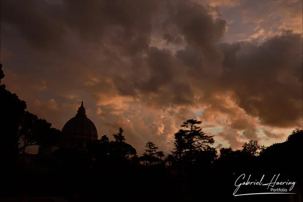 Dramatic sunset sky over the dome of Saint Peter’s Basilica in Rome