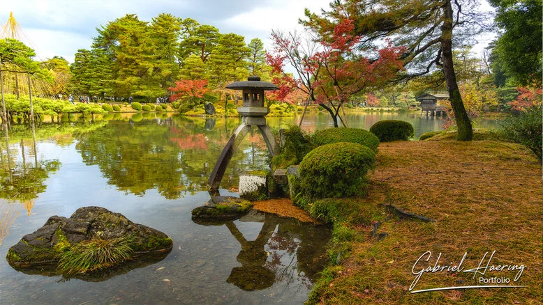 Autumn foliage in Kenrokuen Garden with maple trees in yellow, orange, and red