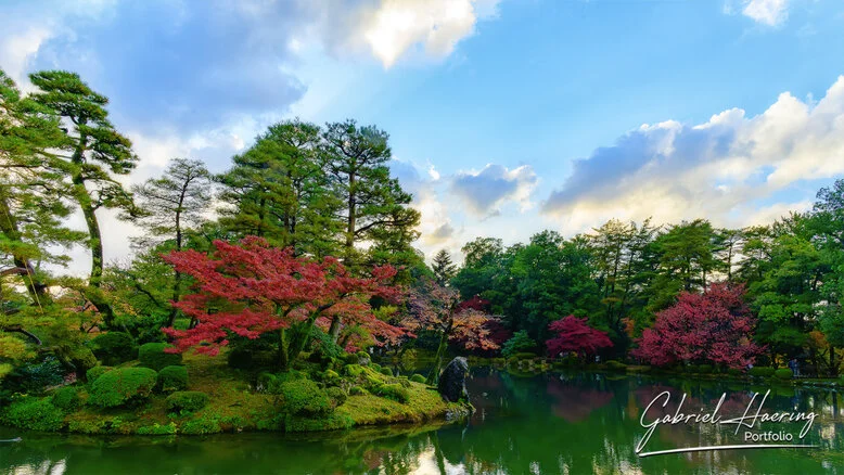 Autumn foliage in Kenrokuen Garden with maple trees in yellow, orange, and red
