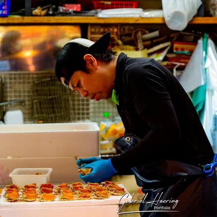 Crowded Ōmichō Market in Kanazawa during lunchtime with food stalls and visitors