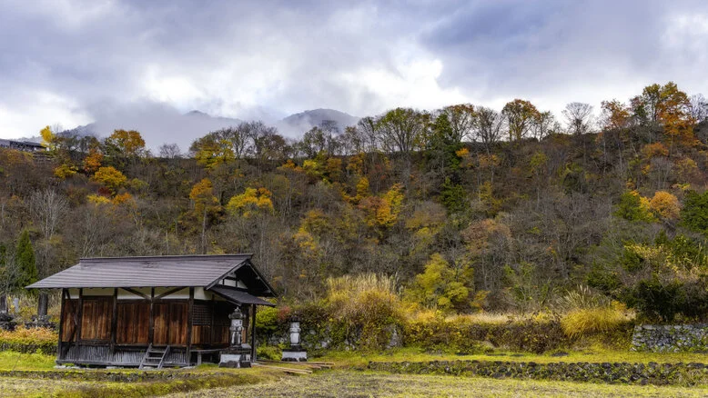 Panorama of Shirakawa-Go village and valley forest in autumn foliage